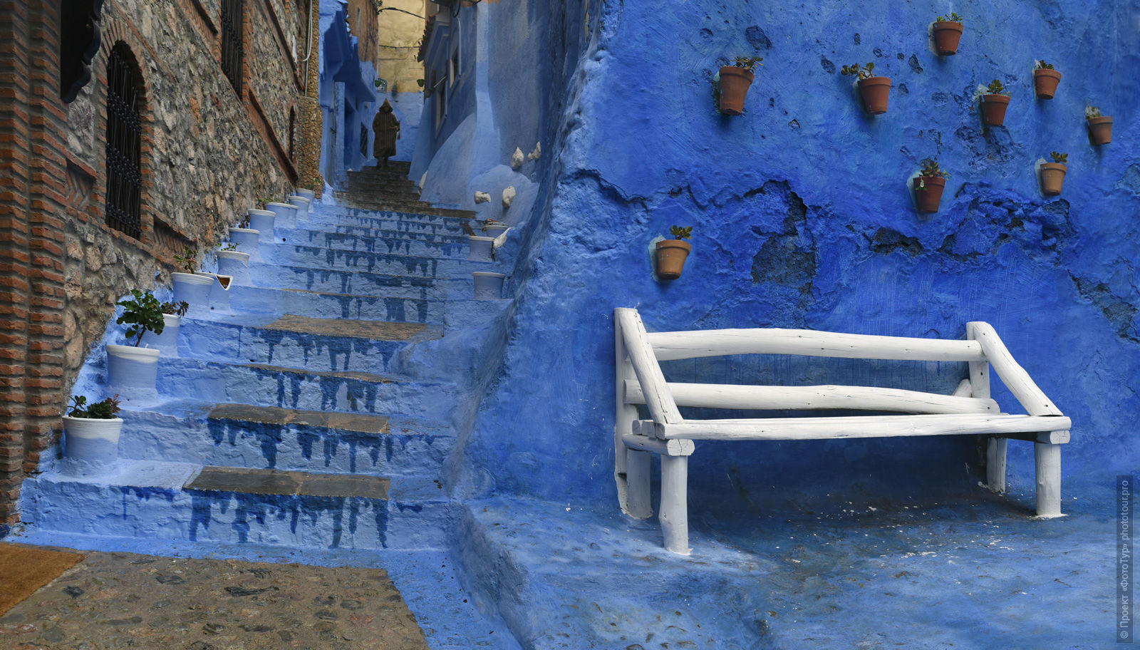White bench in the blue medina of Chefchaouen, Morocco. Adventure photo tour: medina, cascades, sands and ports of Morocco, April 4 - 17, 2020.